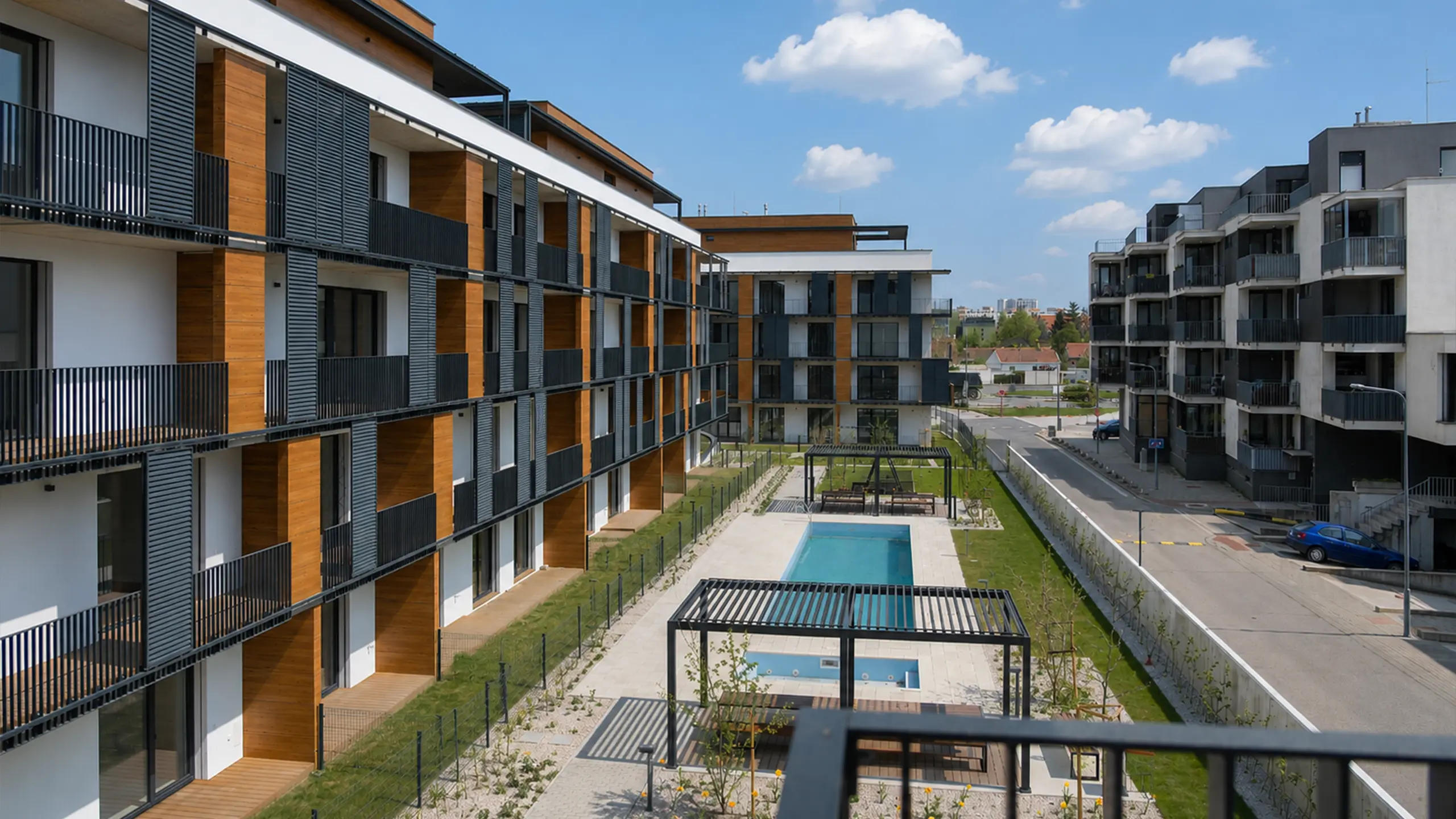 View of the internal community area of the Laurin dvor residential development in Bratislava. A private relaxation zone with a swimming pool, landscaped greenery and shared outdoor spaces complements the modern living environment focused on comfort and community life. - obrázok 8