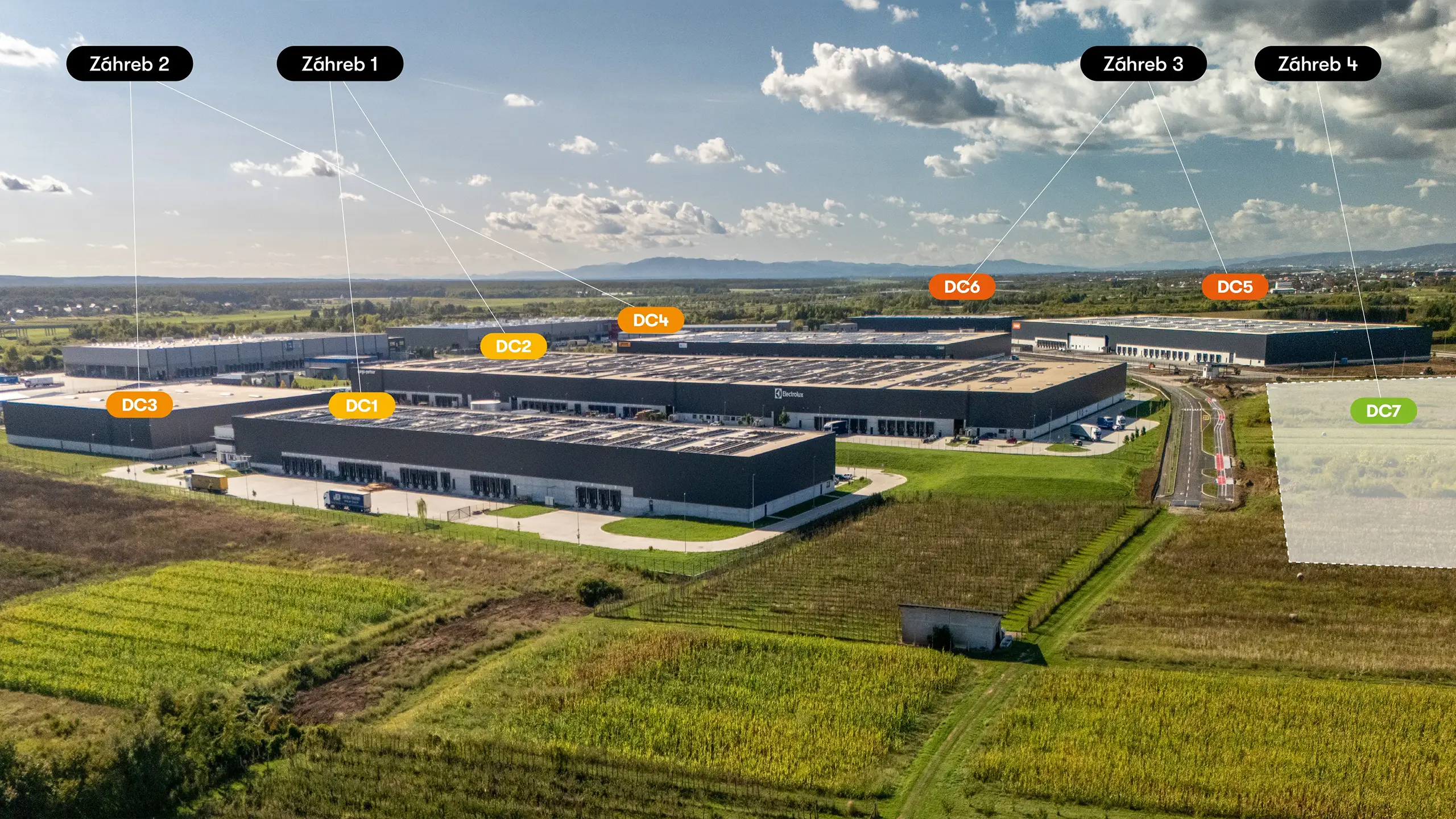 Industrial Project Zagreb 4 – panoramic aerial view of the fourth expansion phase of the Zagreb logistics park within the context of the entire industrial development. The photograph shows existing facilities from previous phases, land designated for further expansion, and the park’s strategic location with excellent transport connections. Upon completion, the entire industrial park will provide more than 210,000 m² of premium leasable space featuring photovoltaic systems and BREEAM certification. - obrázok 5